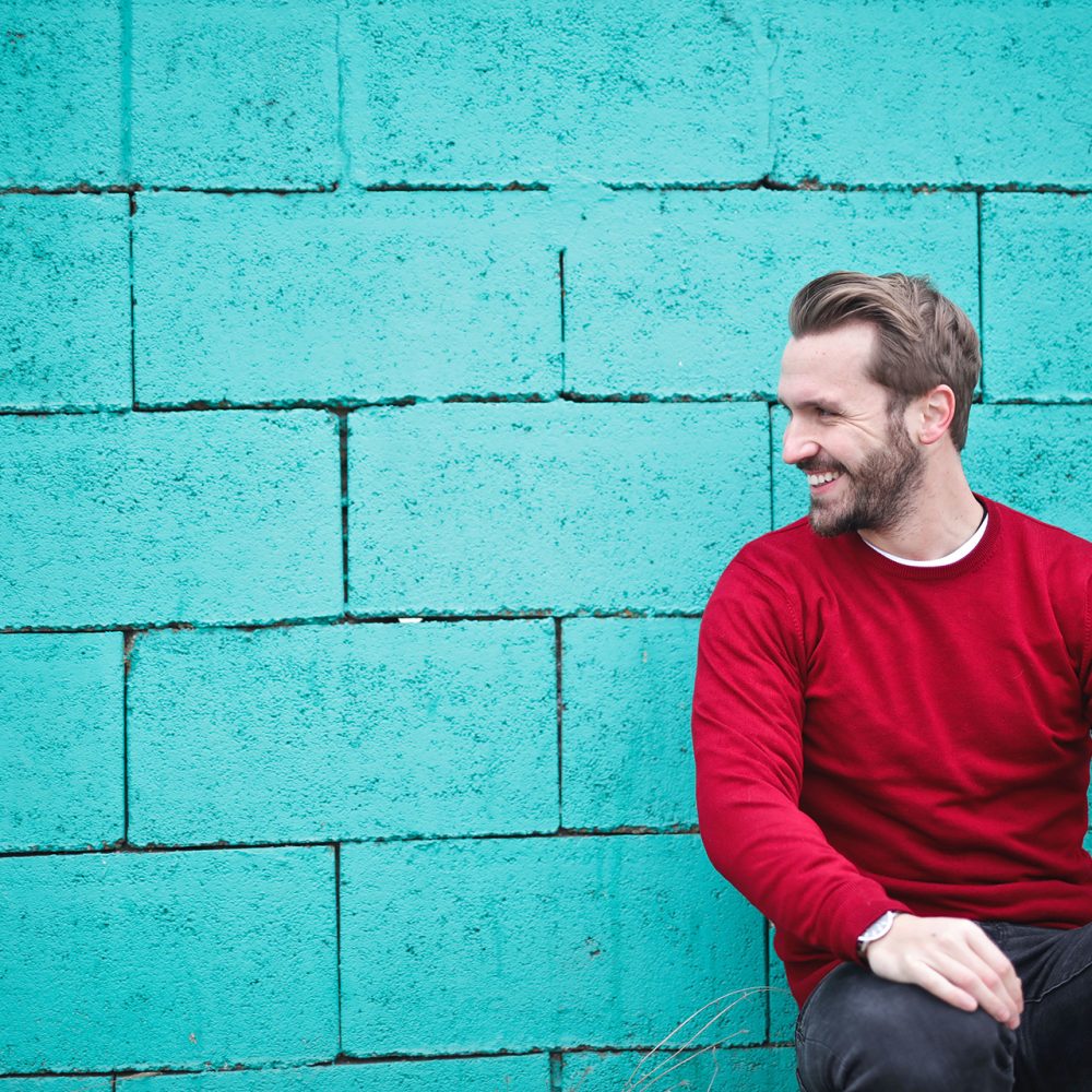 man smiling sitting casually