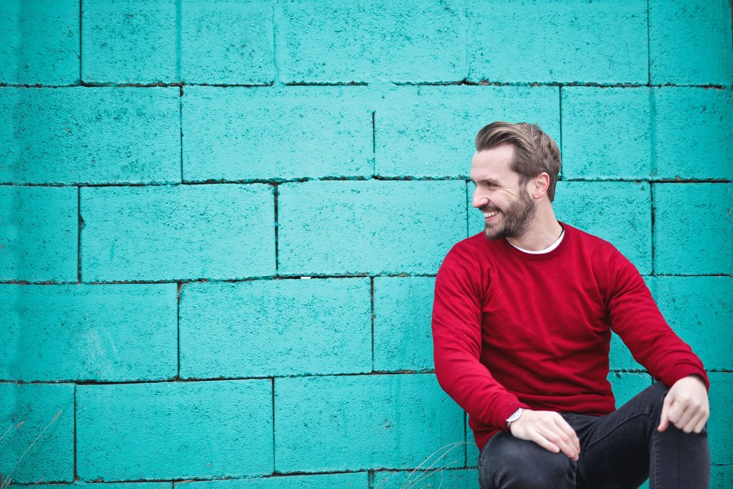 man smiling sitting casually